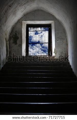 Exotic ancient staircase coming up  from an underground catacomb into a blue cloudy open space.