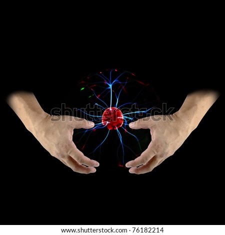 A pair of hand emerging from the shadow holding onto a plasma energy ball as futuristic renewable energy source.
