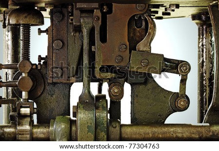 Closeup of an antique copper mechanical engine parts on a metal stamping machine.