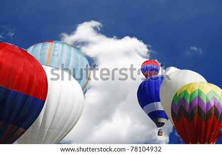 Colorful hot air balloons ready to take off on a beautiful blue sky with copyspace for text.