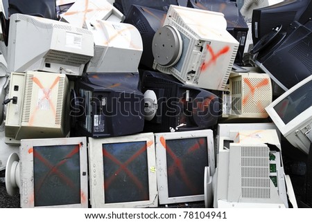 A pile of discarded computer monitor and equipment ready for recycling.