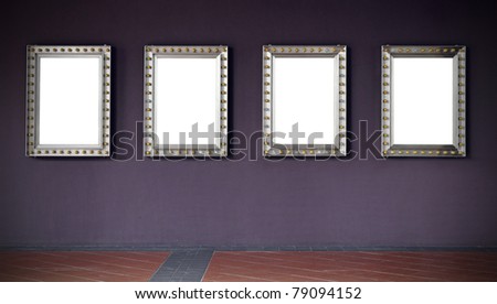 A row of four picture frames with incandescent light bulb surrounding its border hanging on a purple wall, with copy space for text and images along a rustic clay tile pavement in an exhibition hall.