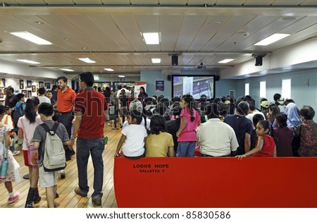PORT KLANG, MALAYSIA - OCTOBER 1:Visitors at the MV Logos Hope theater room on October 1, 2011 in Port Klang, Malaysia. The 132.5m ship host the world's biggest floating book fair with 5000 book title