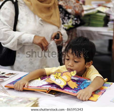 SERDANG, MALAYSIA - OCTOBER 9: Unidentified kid at the Big Bad Wolf book fair on October 9, 2011 in Malaysia Agro Exposition Park Serdang, Malaysia. The book fair is the world biggest with 1.5m title
