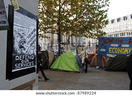 LONDON - NOVEMBER 1: Protest poster on columns at the Occupy London Stock Exchange anti-capitalist protest on November 1, 2011 at St Paul\'s Cathedral churchyard in London, England.
