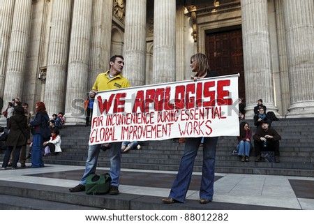 LONDON - NOVEMBER 1: Protesters with a big protest banner at the Occupy London Stock Exchange anti-capitalist protest on November 1, 2011 at St Paul\'s Cathedral churchyard in London, England.