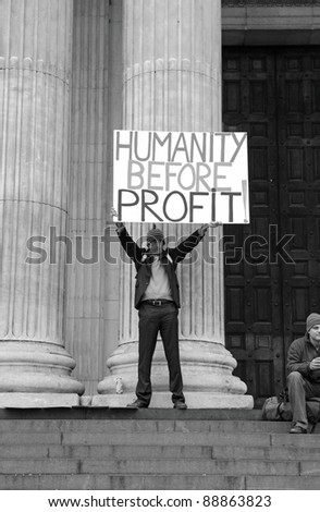 LONDON - NOVEMBER 11: A protester with protest placard at the Occupy London Stock Exchange anti-capitalist protest on November 11, 2011 at St Paul\'s Cathedral churchyard in London, England.
