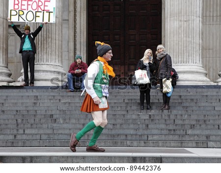 LONDON - NOVEMBER 11: An old protester in a dance outfit at the Occupy London Stock Exchange anti-capitalist protest on November 11, 2011 at St Paul\'s Cathedral churchyard in London, England.