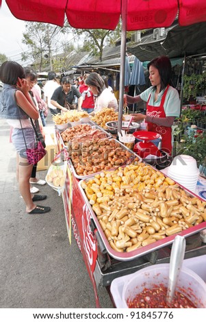 BANGKOK - DECEMBER 24: Street food vendor in a weekend bazaar on December 24, 2011 in Chatuchak Market, Bangkok. Chatuchak Market is the world largest weekend market covering 27 acre with 15,000 booth