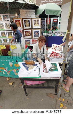 BANGKOK - DECEMBER 24: An art dealer in a weekend bazaar on December 24, 2011 in Chatuchak Market, Bangkok. Chatuchak Market is the world largest weekend market covering 27 acre with 15,000 booth.