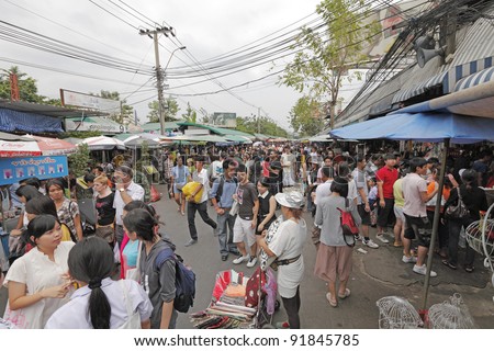 BANGKOK - DECEMBER 24: Shoppers in a crowded weekend bazaar on December 24, 2011 in Chatuchak Market, Bangkok. Chatuchak Market is the world largest weekend market covering 27 acre with 15,000 booth