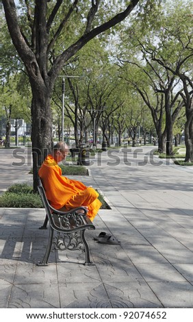 BANGKOK - DECEMBER 25: A monk meditating in a park on December 25, 2011 in Sanam Luang Park, Bangkok. Buddhist monk received alms every year end in Sanam Luang Park before embarking on a 3 month fast.