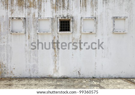 A weathered white plaster wall with window frame and blank space for text, for textural background.