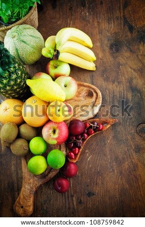 Organic Fruit variety on wood. Tropical exotic food concept.