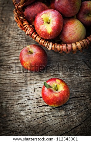 Fresh Harvest Of Apples. Nature Theme With Red Grapes And Basket On Wooden Background. Nature Fruit Concept.