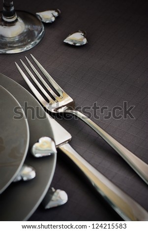Restaurant series Valentines day dinner with table setting in pink and gray and holiday elegant heart ornaments Restaurant series Valentines day dinner with table setting in pink and gray and holiday elegant heart ornaments