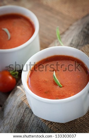 Fresh tomato soup with cherry tomatoes and fresh herbs and copyspace