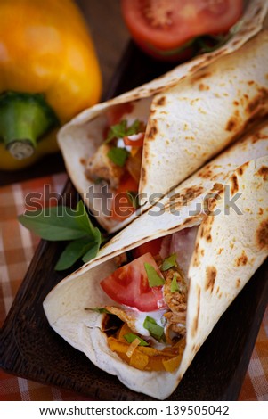 Mexican food. Fresh tortilla fajita wraps with chicken and vegetables