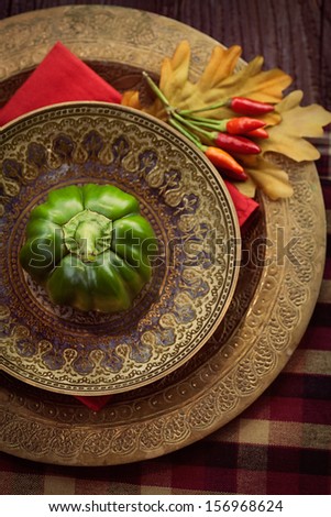 Restaurant autumn table setting. Place setting with oriental plates and autumn decoartion.