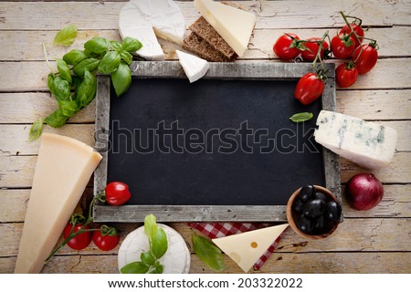 Italian cooking. Fresh ingredients with pasta for italian cuisine. Cheese variety on chalk board