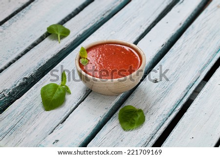 Tomato soup in rustic setting. Vegetable appetizer.