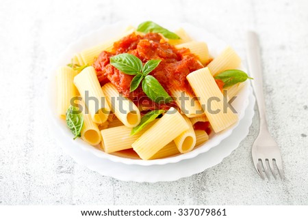Pasta with Tomato Sauce and Basil on a Fork. Italian food. Mediterranean cuisine