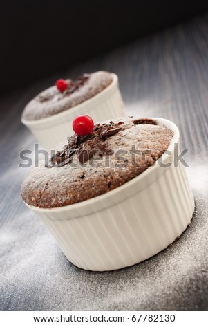 Chocolate souffle with chocolate chips and red currant