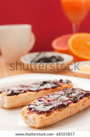 Breakfast with butter and jam and freshly squeezed juice.