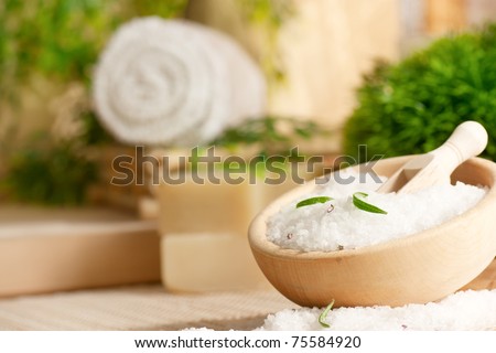 Spa setting with bath salt and towel.
