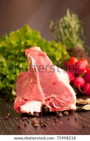 Raw veal meat with fresh vegetables and rosemary