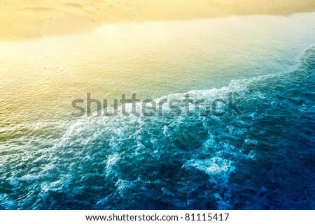Sea waves background  with golden sand and foam ocean water