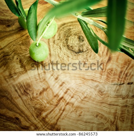 Summer olives nature background with fresh olive branch and olive wood