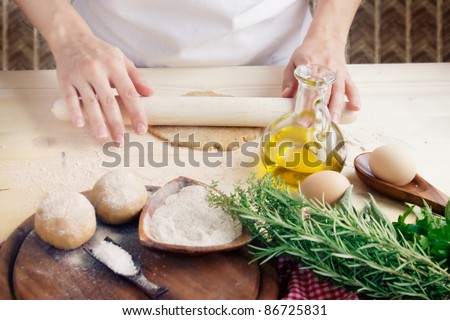 Woman is kneading dough balls.