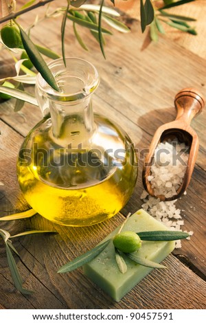 Natural spa setting with olive  and olive oil products: bath salt, natural soap and olive oil.