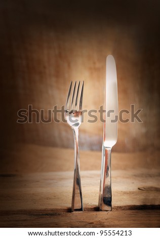 Restaurant menu series. Country place setting. Fork and knife in rustic country table setting.