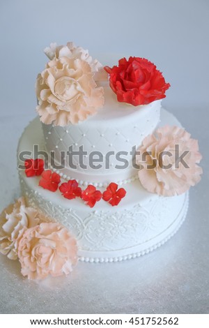 fill frame of birthday cake or wedding cake decorated by edible rose bloom on silver stand with white background