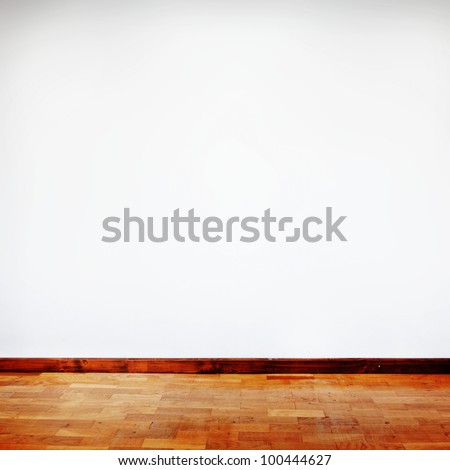 square composition of empty room with white wall and wooden flor