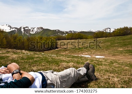 young man relaxing in the nature in front of beautiful landscape