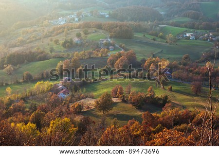 high view of hill and little village in italian mountains