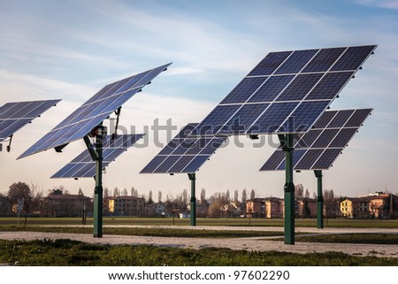 group of solar panel in the middle of land on sky and building background