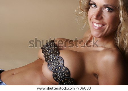 Blond female model smiling and wearing a medieval style belt over breasts