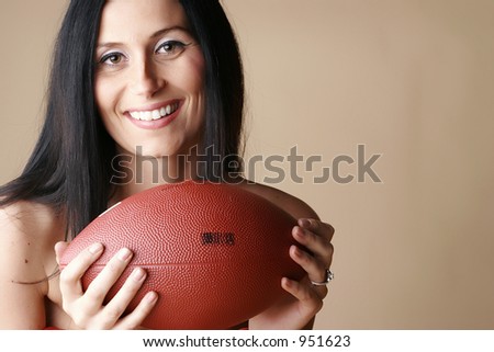 Brunette Female smiling holding a football
