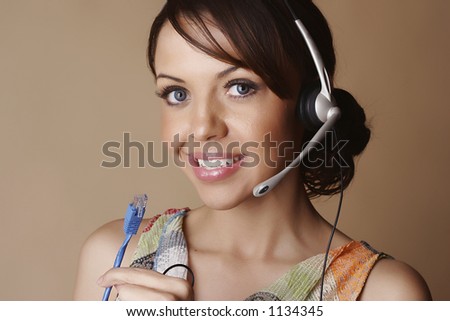 Female wearing a headset and holding a network cable