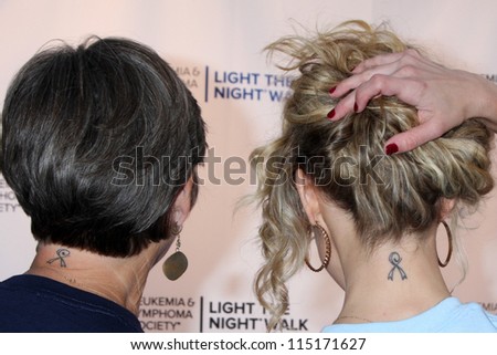 LOS ANGELES - OCT 6:  Char Griggs, Linsey Godfrey show off their cancer survivor ribbon tattoo at the Light The Night Walk  at Sunset Gower Studios on October 6, 2012 in Los Angeles, CA