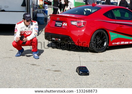 LOS ANGELES - MAR 23:  Michael Trucco playing with a remote control car at the Toyota Pro/Celebrity Race training at the Willow Springs International Speedway on March 23, 2013 in Rosamond, CA