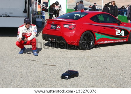 LOS ANGELES - MAR 23:  Michael Trucco playing with a remote control car at the Toyota Pro/Celebrity Race training at the Willow Springs International Speedway on March 23, 2013 in Rosamond, CA