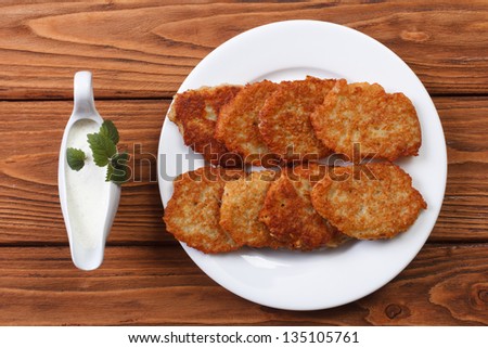 Potato pancakes with sour cream sauce top view