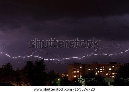 Thunderstorm with lightning in the night sky over the city