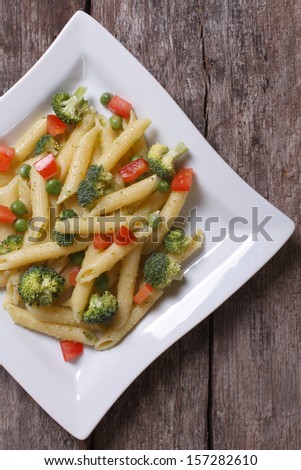Pasta with vegetables on the table in a square plate top view