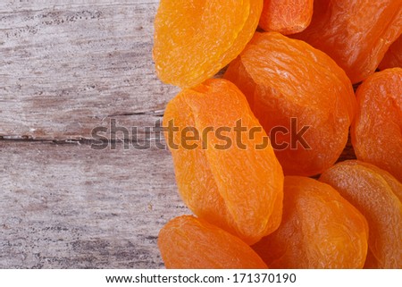 Large dried apricots close-up on an old wooden table. macro